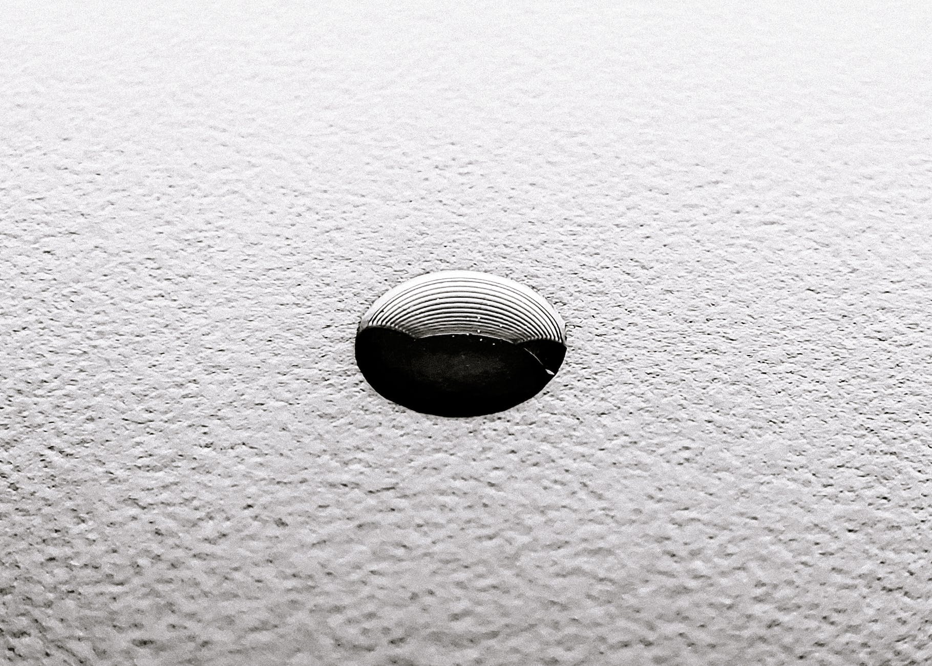 small ink drop o white textured surface